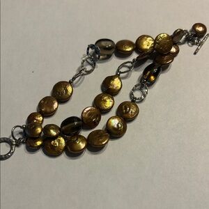 Silpada Gold and Silver triple Strand Bracelet. Goldish mother of pearl